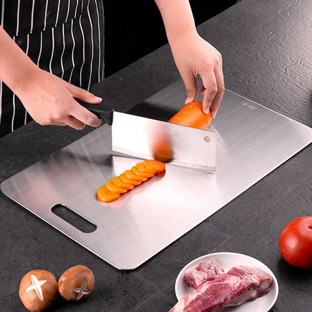 cutting carrot on stainless steel board